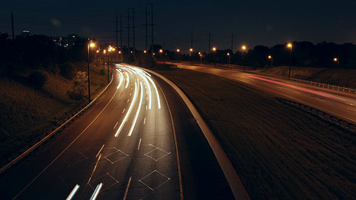 Don Valley Parkway time lapse at night, Toronto. Corner with streaking lights. HD Video.