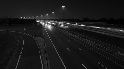 Highway 401 in Toronto. Time lapse of lanes at night. Black and white. HD video.