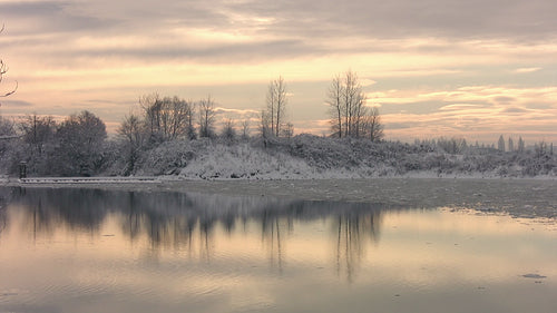 Beautiful winter river after snow storm. Delicate violet and orange light. HD video.