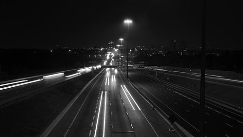Highway 401 in Toronto from Don Mills overpass. Wide. Night time lapse. Black & white. HD video.