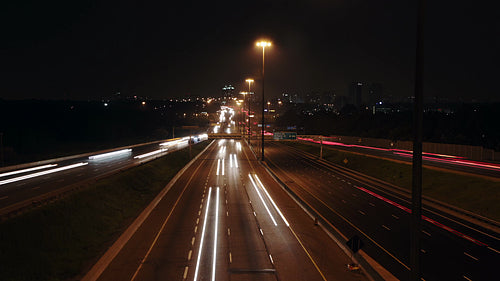 Highway 401 in Toronto from Don Mills overpass. Wide. Time lapse of lanes at night. HD video.