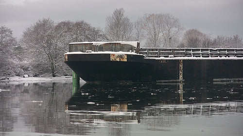Large barge detail of front. Snowy winter scene. Fraser River, B.C. HD video.