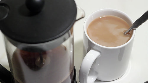 Fresh coffee with cream or milk. Mug in focus. HD video.