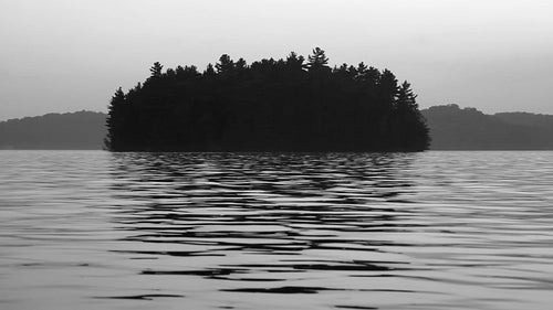 Morning island at dawn with water reflections. Black and white. HD video.