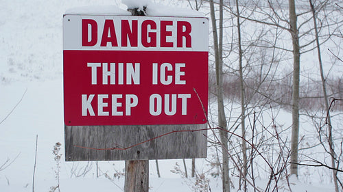 Danger. Thin ice keep out. Snowy day in rural Ontario, Canada. HD video.