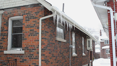 Winter house. Snow falls and icicles hang. Winter in Toronto, Ontario, Canada. HD video.