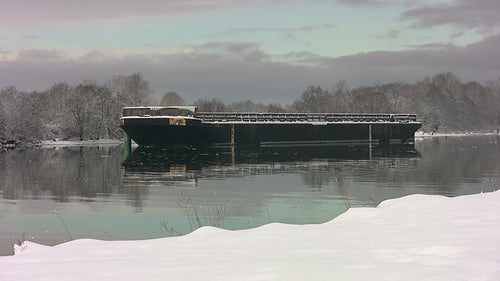 Large barge on Fraser River. Snowy winter scene. HD video.