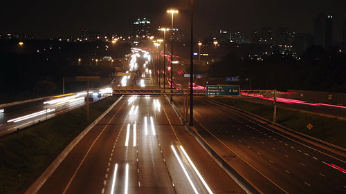 Highway 401 in Toronto from Don Mills overpass. Time lapse of lanes at night. HD video.