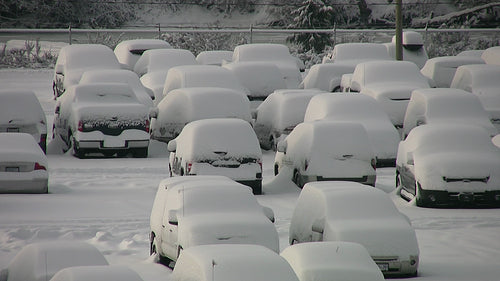 Snowstorm parking lot. Closeup. Truck drives around snowy parking lot. HD video.