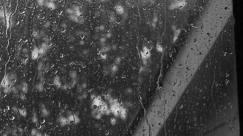 Window with raindrops during summer storm. Black and white. HD video.