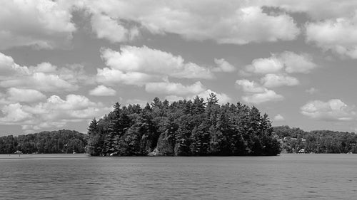 Summer island in Muskoka, Ontario, Canada. Time lapse clouds. Black and white. HD video.