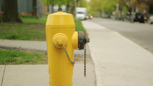 Yellow fire hydrant in the suburbs. HD video.