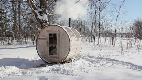 Winter sauna. Front view. Wood burning sauna in rural Ontario on Winter day. HD video.