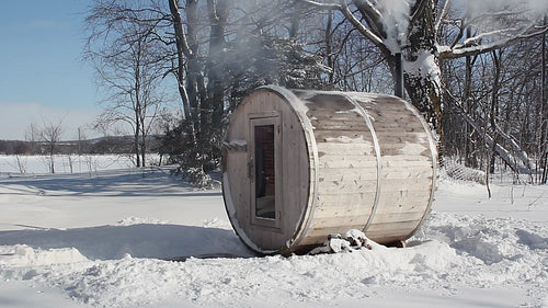 Winter sauna. Wood burning sauna in rural Ontario on freezing Winter day. HD video.
