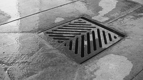 City drain with good audio. Black and white. HD video.
