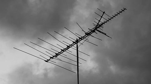 Vintage TV antenna moving in the breeze. Stormy sky. HD video.