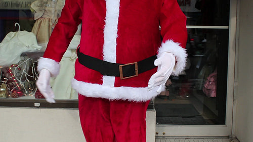 Freaky robot santa dances outside store. Detail of belt, arms and belly. Toronto. HD video.