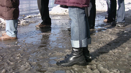 People standing in slush in the city. HD video.