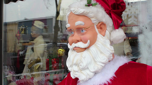 Robot santa dances outside store. Detail of face from side. Toronto, Ontario, Canada. HD video.