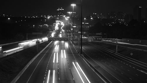 Highway 401 in Toronto from Don Mills overpass. Night time lapse. Black & white. HD video.