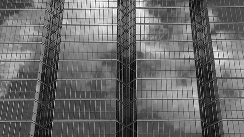 Office windows reflect steam. Black and white. HD video.