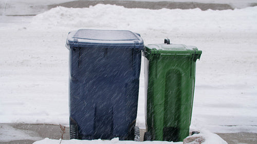 Recycling and garbage bins on sidewalk in snow. No logos. Toronto, Canada. 4K.