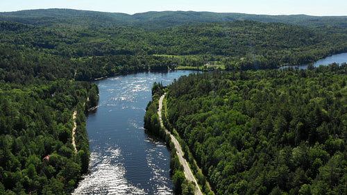 Drone flight over sparkling Gatineau River. Summer in Wakefield, Quebec. 4K.