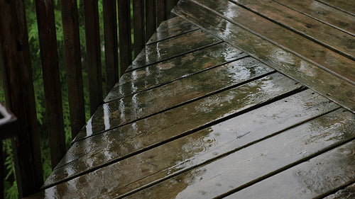 Summer rain falling on wooden deck. Half-speed 4K Clip. Ontario, Canada. 4K.