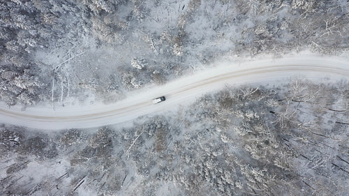 Drone following pickup truck on rural winter road. 4K.