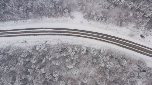 Winter road. Drone birdseye view flying in a snowstorm. Ontario, Canada. 4K