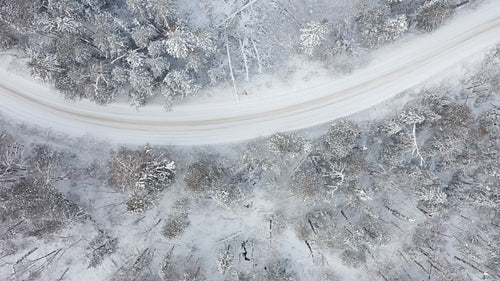 Drone following path of curving winter corner. 4K.