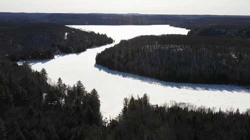 Sunny winter morning aerial drone shot. Winter on Drag Lake, Ontario. 4K.
