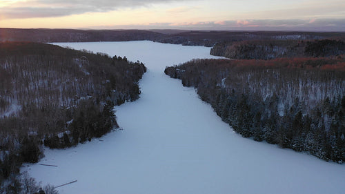 Slow descending aerial drone shot. Winter on Drag Lake, Haliburton, Canada. 4K.