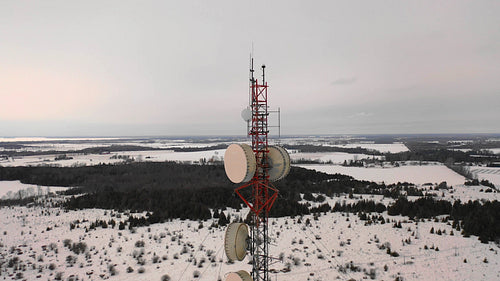 Drone shot of communications tower antenna. Winter in Ontario, Canada. 4K.