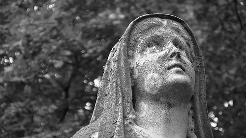 Madonna statue looks skyward. Detail. Black and white. HDV footage. HD.