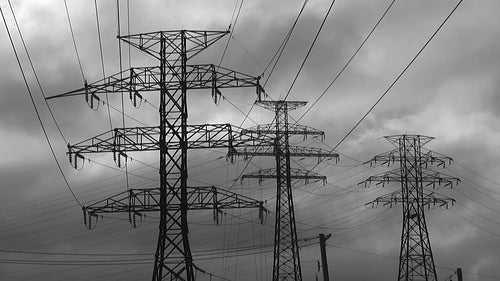 Electricity. Electrical pylons with time lapse clouds. Black and white. HDV footage. HD.