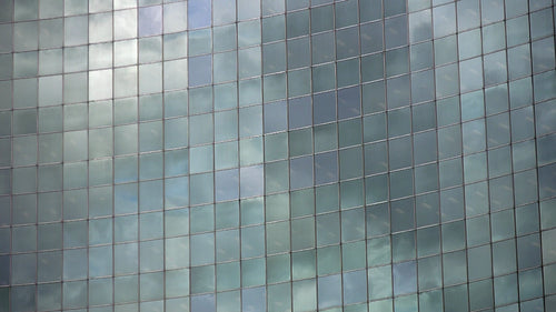 Mellow time lapse clouds reflected in curved windows of office. Toronto. HD video.