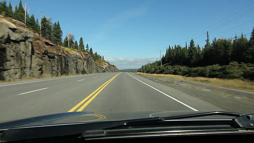 POV driving on sunny stretch of Northern Ontario highway. Autumn. HD.
