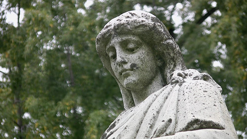 Grieving cemetery statue. Portrait, with detail of face. HD video.