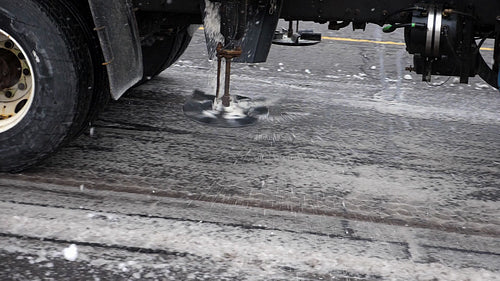 Truck mounted salter applying salt to snowy street. Toronto, Canada. HD.