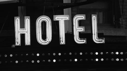 Old hotel sign. Neon with blinking lights. Toronto, Canada. Black and white. HD video.
