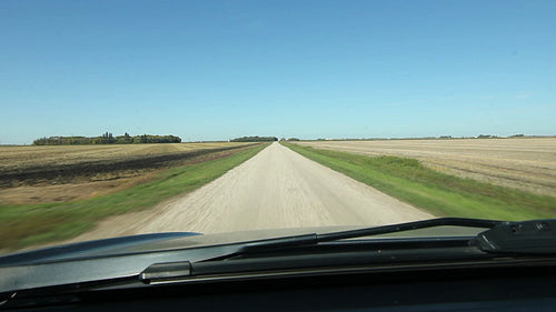 Driving on prairie road between farmers fields. Manitoba, Canada. HD.