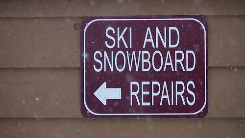 Ski and Snowboard repairs sign. British Columbia, Canada. HD video.