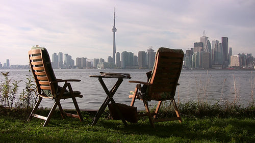 Two chairs with view of Toronto from Toronto islands. Circa 2008. HDV footage. HD.