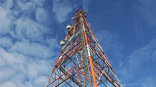 Red and white communication tower. Low angle. Timelapse. HD.