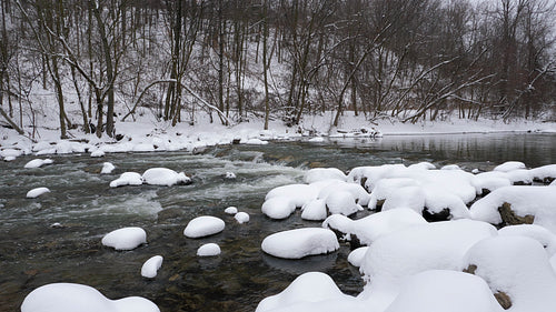 Winter river. Snow on rocks and on forest riverbank. Don River, Toronto. 4K.
