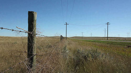 Prairie fence beside road. Alberta, Canada. HD.