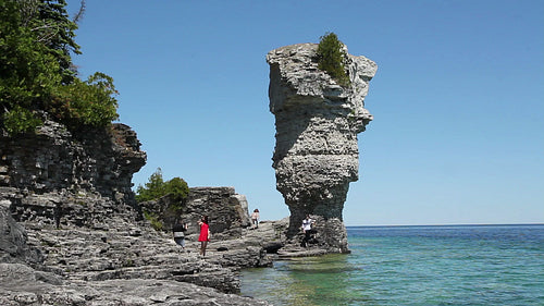 Tourists and flowerpot rock formation in Tobermory, Ontario, Canada. HD.