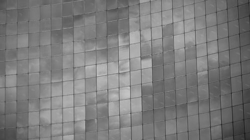 Time lapse clouds reflected in curved windows of office. Toronto. Black & white. HD video.
