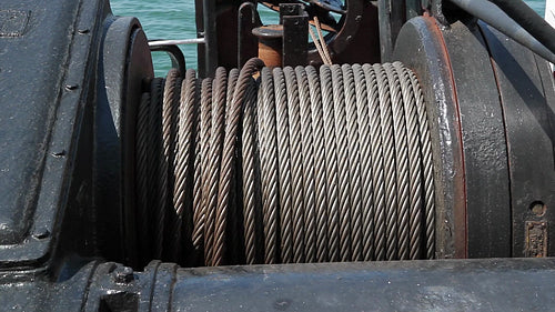 Heavy steel winch cable on ship. HD.